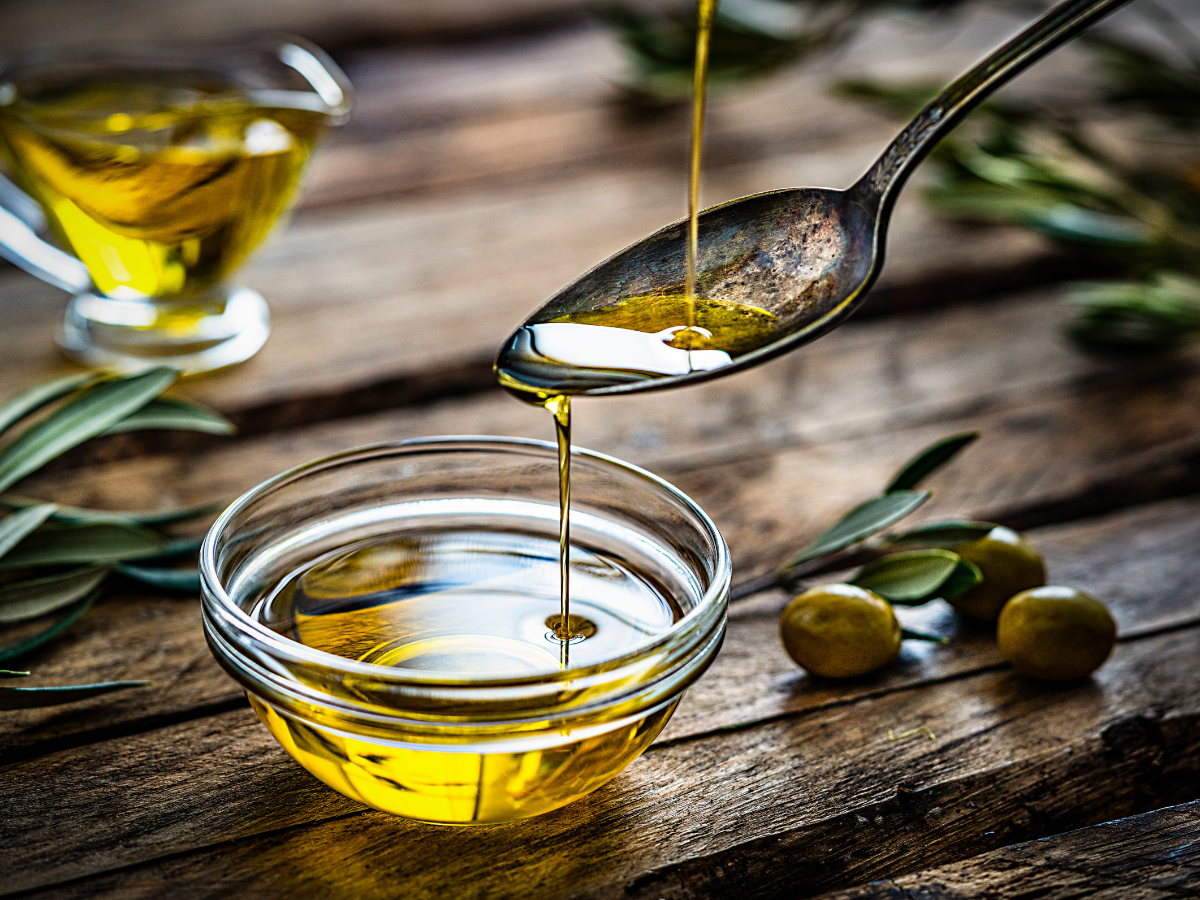 Extra virgin olive oil with fresh olives
